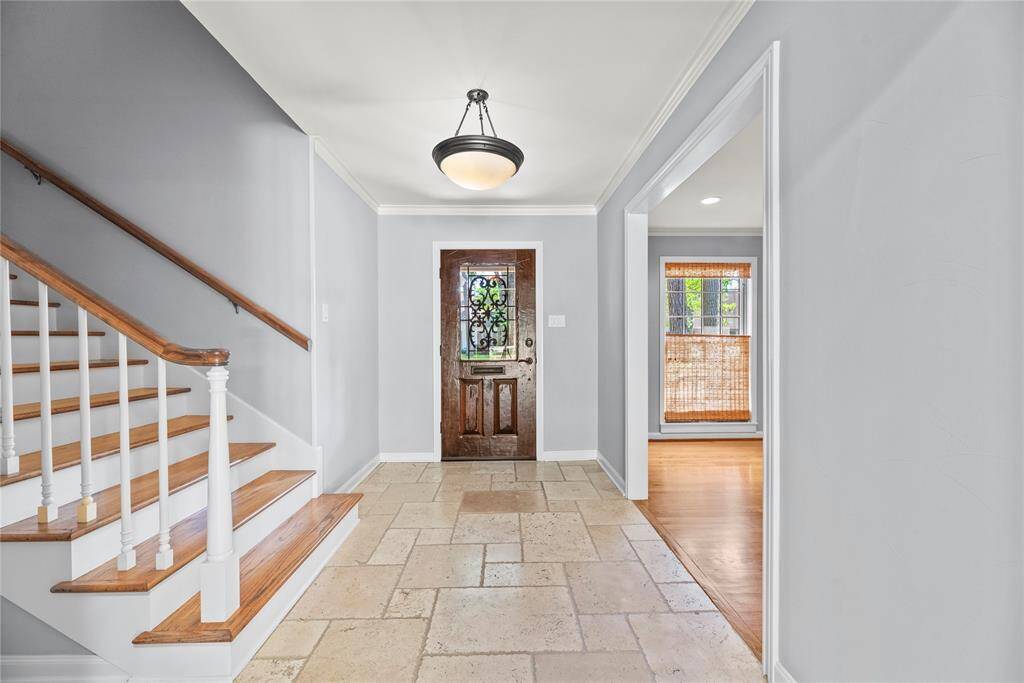 Looking back toward the wood and iron front door, this foyer highlights the open entry with clean lines and great natural light.