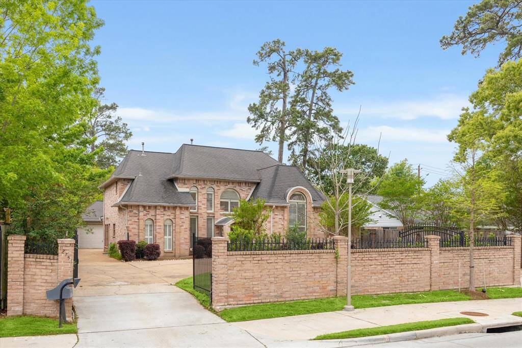 Charming home located in Memorial Bend with circle driveway, gated entry and brick wall for privacy.