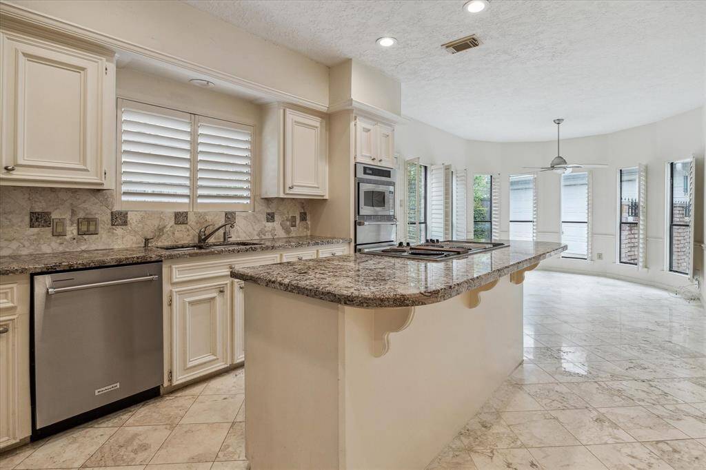 Another view of the spacious kitchen and breakfast room overlooking the backyard.