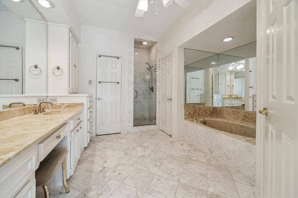 Master bath with soaking tub, separate walk in shower, two closets, and spacious vanity. Marble floors.