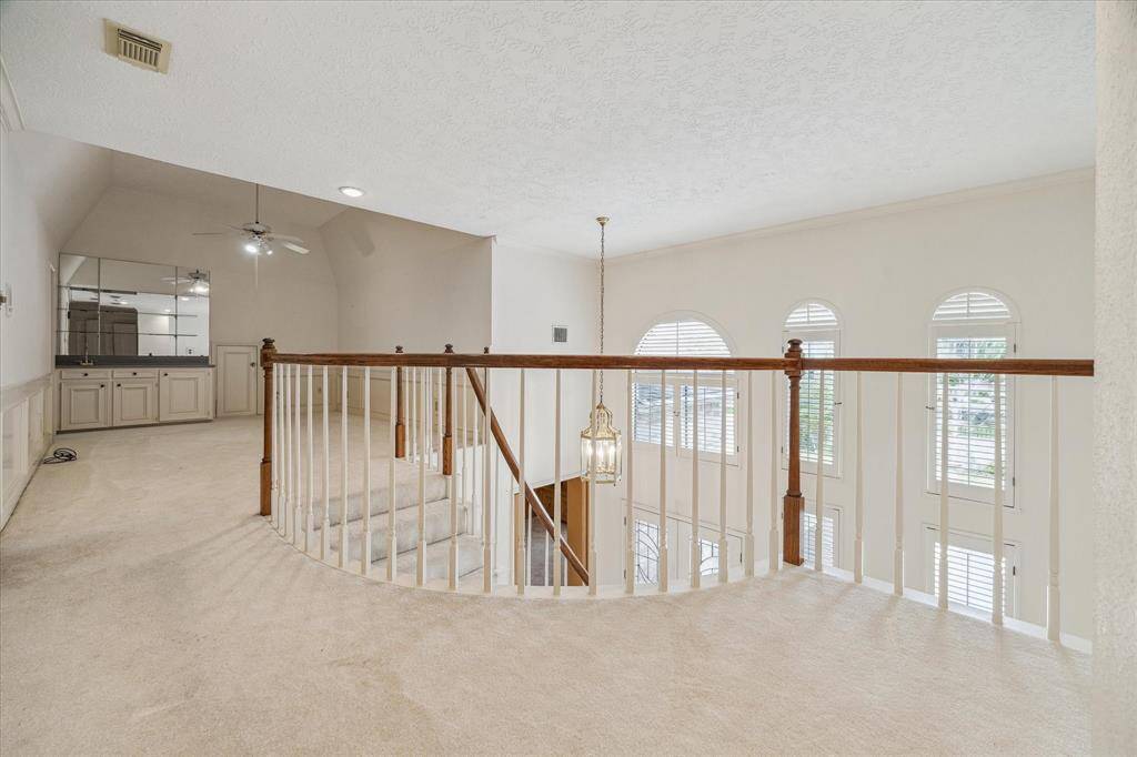 Second floor balcony landing and open to game room/lounge area with bar