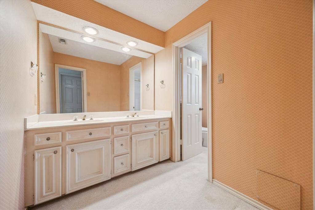 Second floor secondary bathroom with spacious vanity and double sinks.