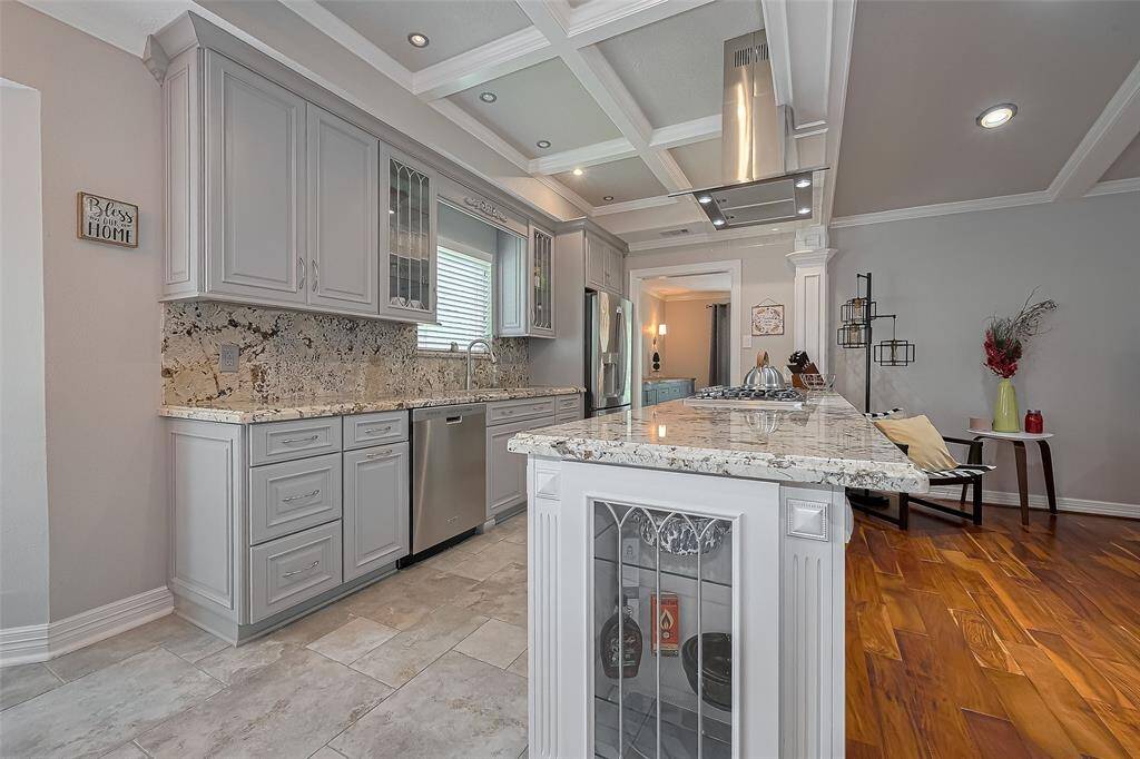 Gorgeous kitchen features granite counters & backsplash, stainless appliances and opens to the family