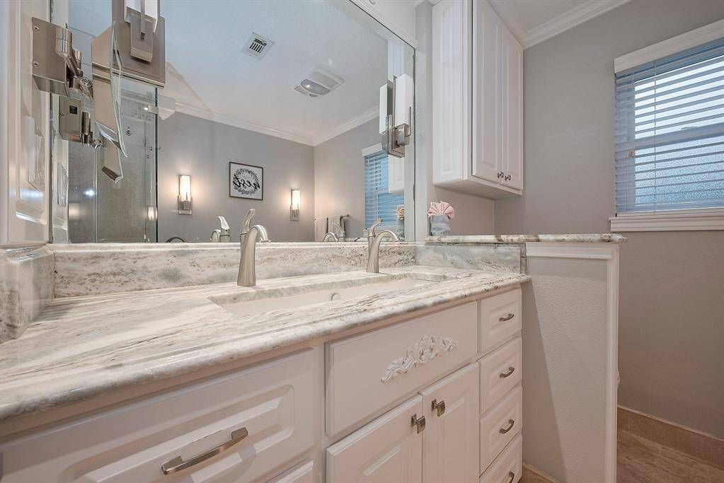 Primary vanity offers plenty of counter space and cabinet storage