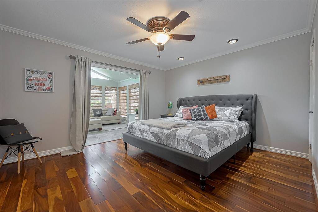 Primary bedroom features wood floors, stunning sunroom and a spa-like retreat for a an en suite bathroom