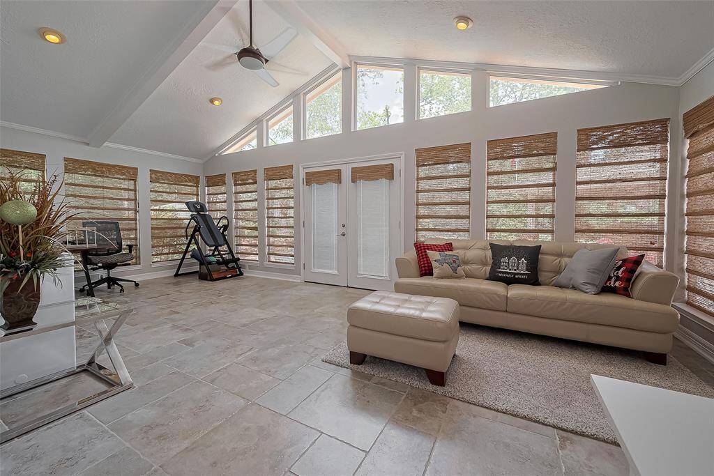 Sunroom of the primary bedroom makes for a great use of space for an office, gym, or study.