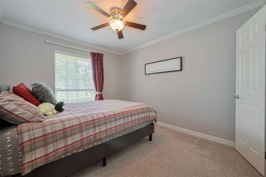 Second bedroom features ceiling fan, walk-in closet and plush carpet