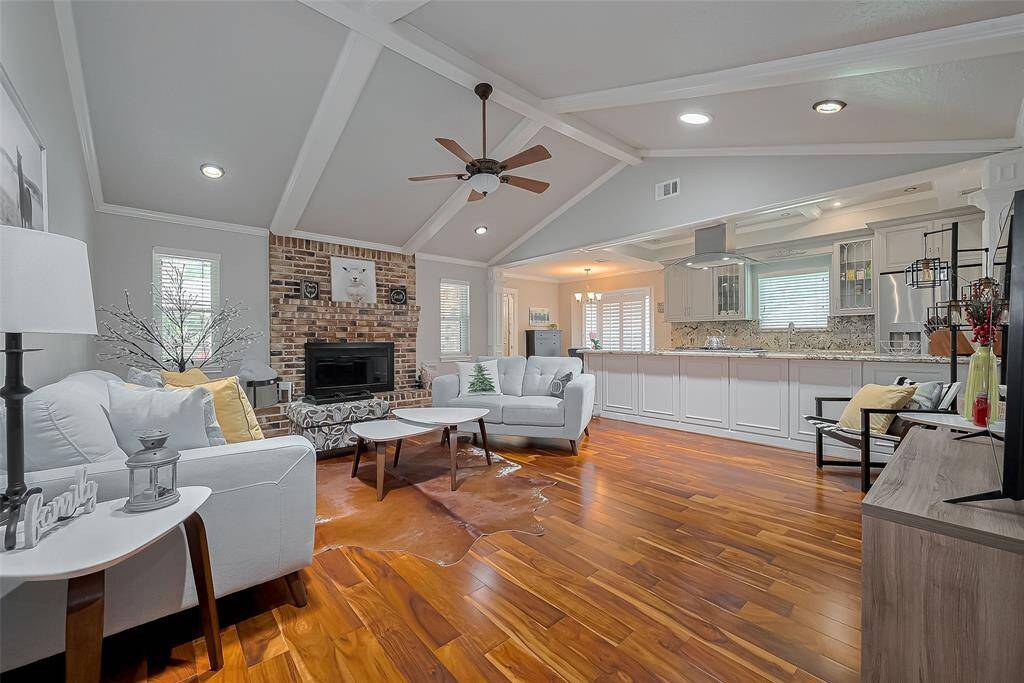 Beautiful family room is bright and open.  Features hardwood floors, recessed lighting, fresh paint and open concept