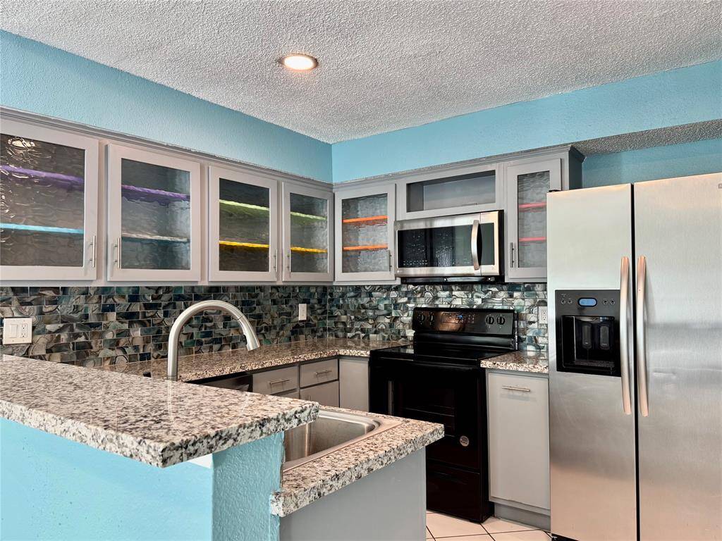 Kitchen with granite countertops and stainless appliances