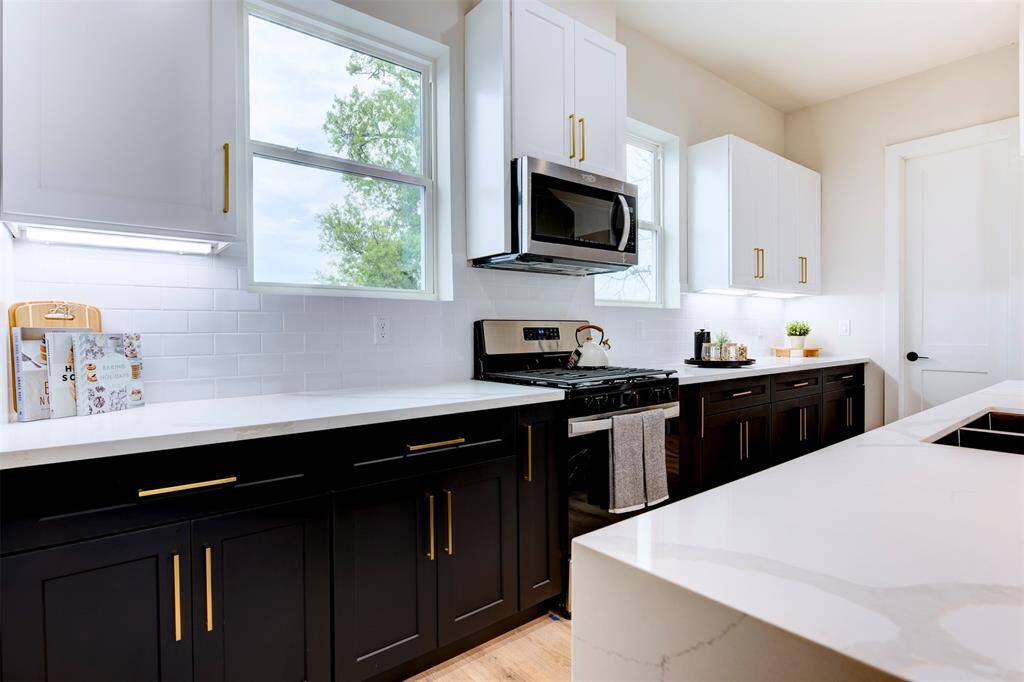 Black cabinets with brass hardware throughout the home