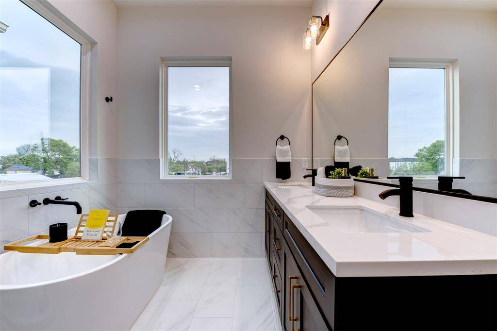 Gorgeous black cabinets with brass silverware and abundant natural lighting