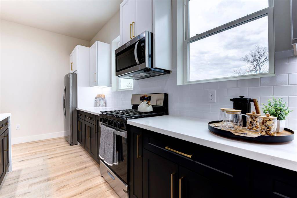 Black cabinets with brass hardware throughout the home