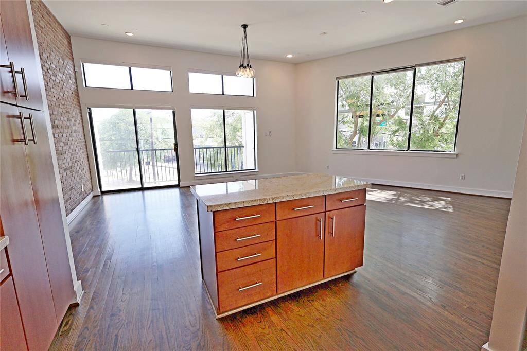 Large windows on each floor flood the interior with natural light, creating a warm and inviting ambiance