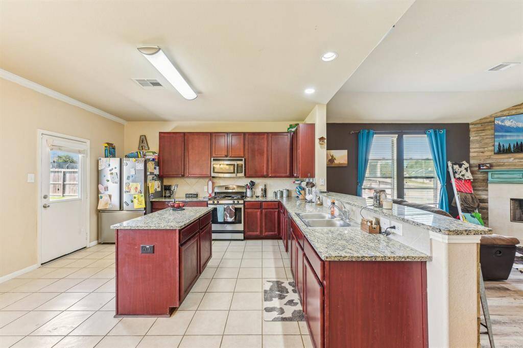 Large kitchen with island, breakfast bar, and open to living area.