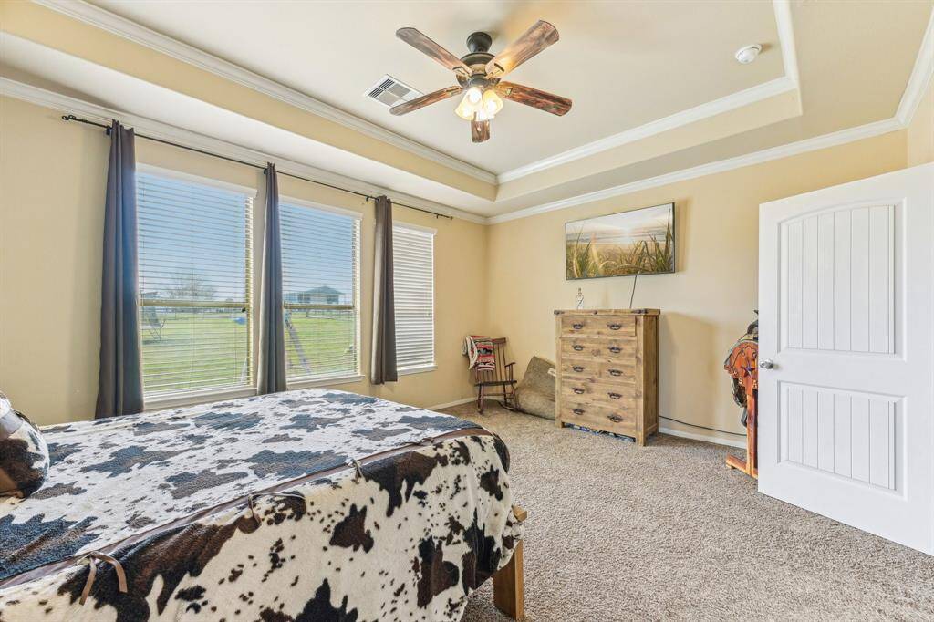 Large primary bedroom over looking back yard.