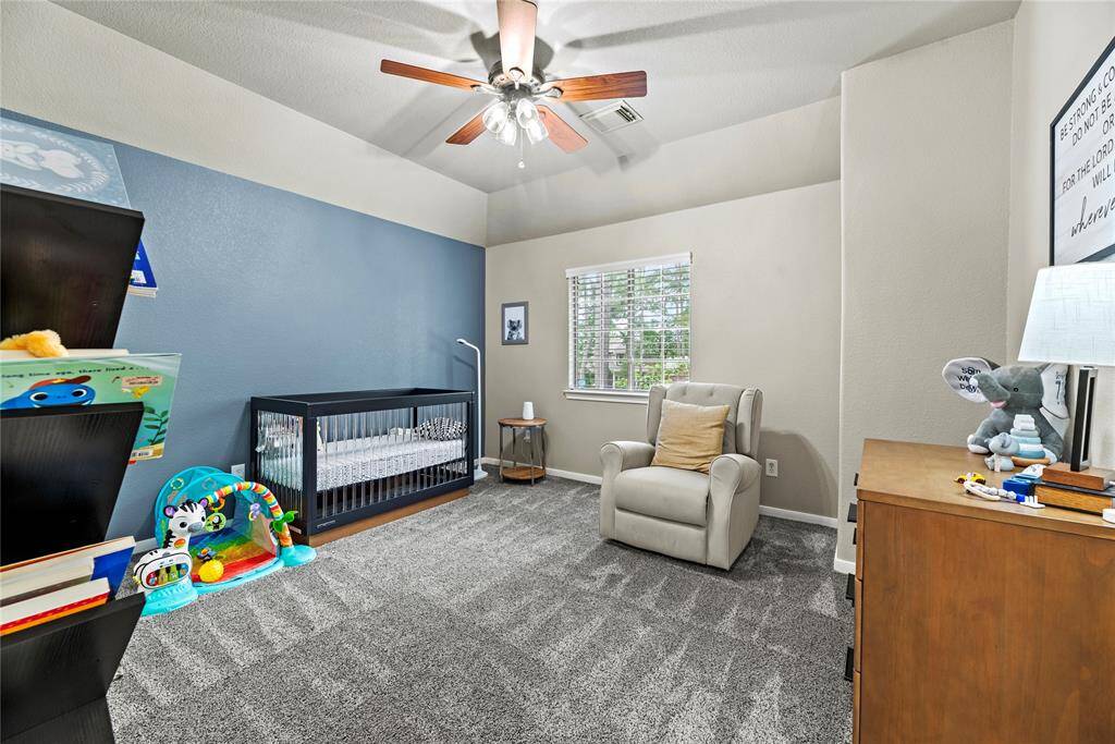 First of 3 secondary bedrooms found on the 2nd floor of the home. They each have walk-in closets, plush carpet and upgraded fans