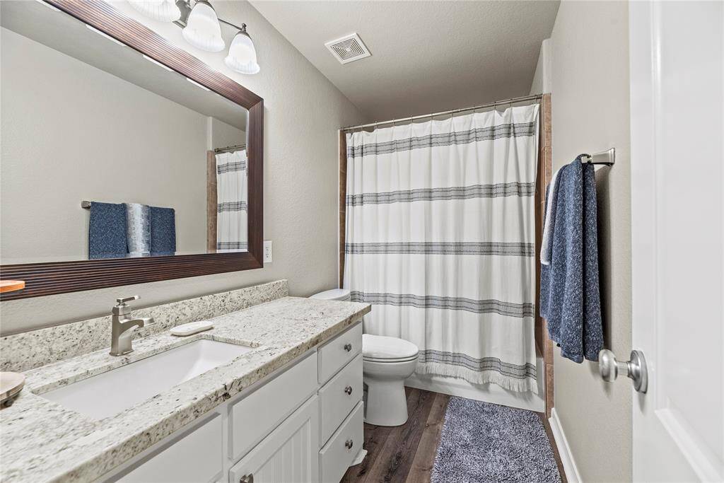 One of 2 full bathrooms found on 2nd floor. These have granite counters, framed mirrors and LPV flooring.