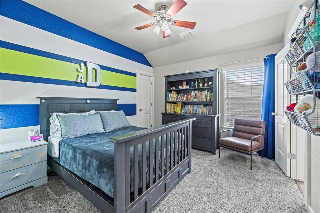 Second of 3 secondary bedrooms found upstairs. Walk-in closets, plush carpet and upgraded fan.