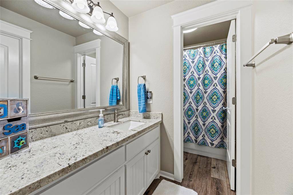 Second of 2 full bathrooms found on 2nd floor. These have granite counters, framed mirrors and LPV flooring. This has a separate shower space for the shared bathroom.