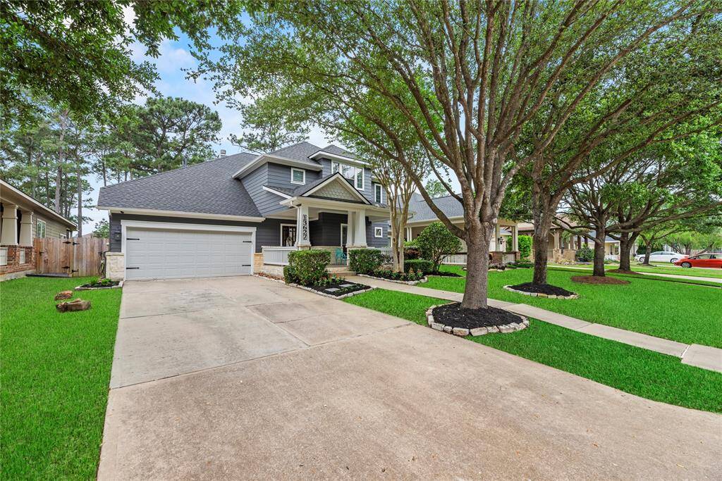 This charming home features a two-story design with a spacious driveway and attached garage.