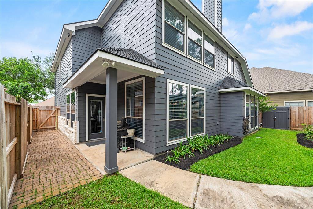 A covered patio leads to the GORGEOUS backyard oasis. The backyard features a well-maintained lawn, a path that leads to a recently constructed pergola and beautiful views of greenspace behind the home.