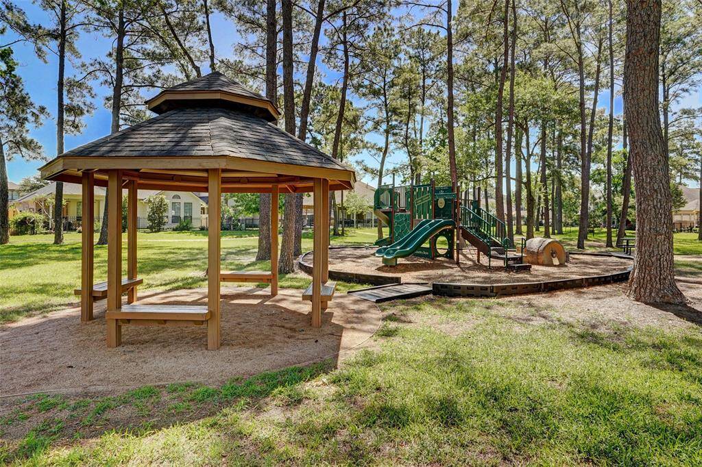 Wooden gazebo and a children's playground found directly behind the home.