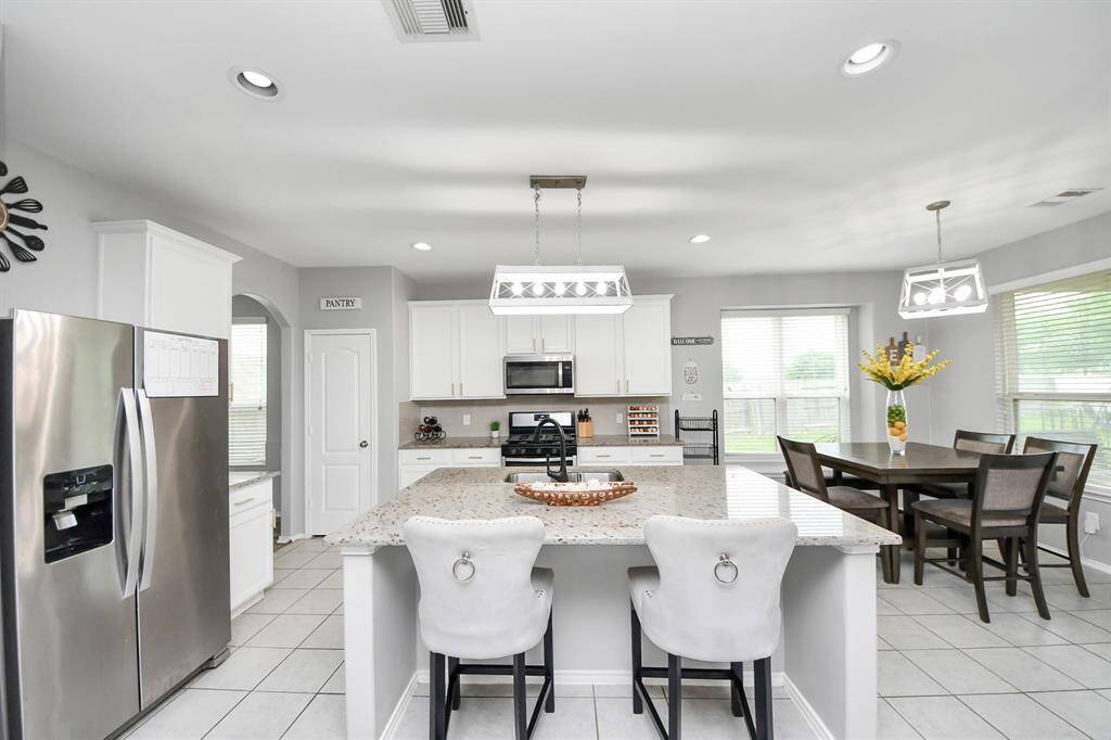 The spacious kitchen is designed for both functionality and style, featuring plenty of counter space, modern appliances, and an open layout that flows seamlessly into the living room—ideal for cooking and entertaining.