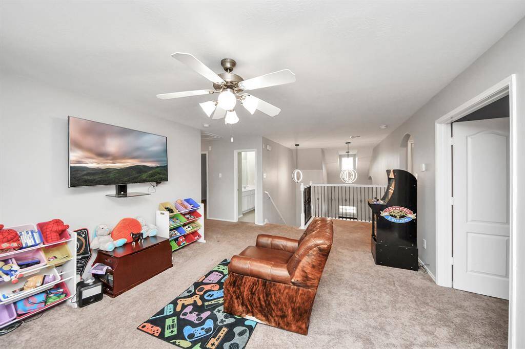 The open upstairs area is currently set up as a fun gameroom, offering plenty of space for entertainment, hobbies, or whatever you envision. It’s a great spot for family time or relaxing with friends.