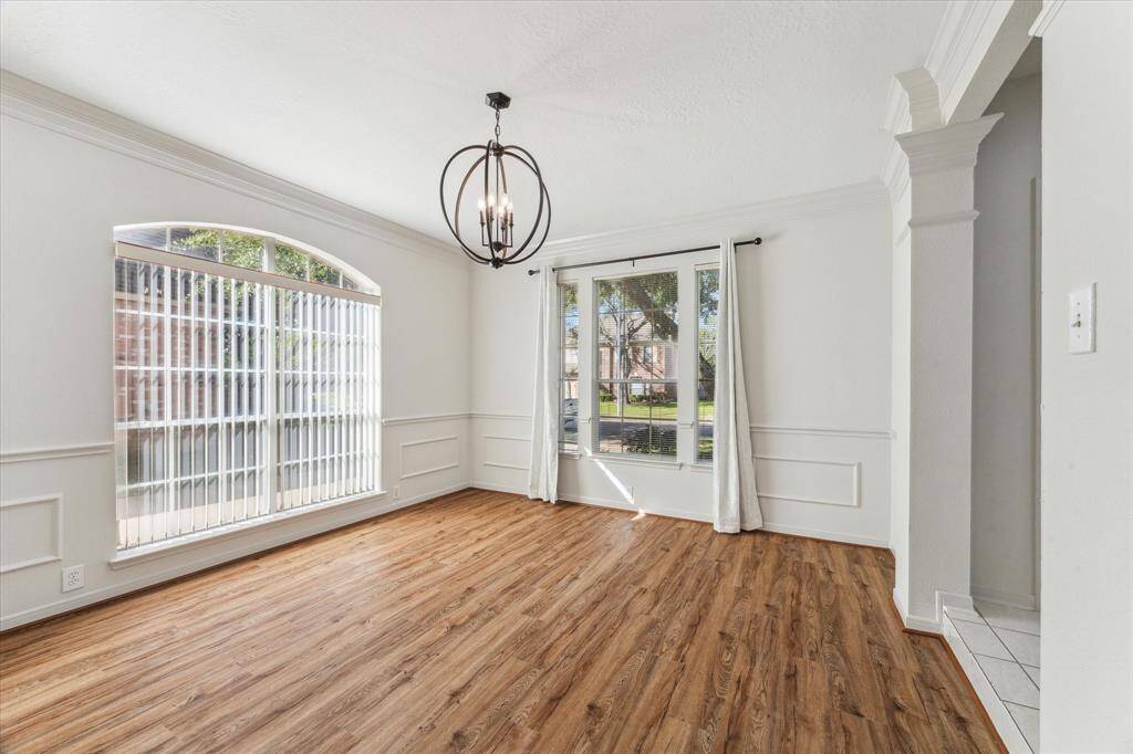 Formal dining with new flooring and lighting.
