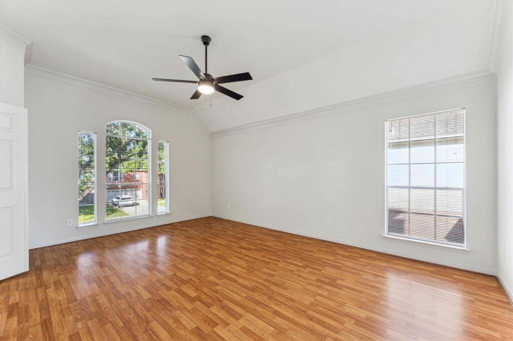 Large primary bedroom with plenty of natural lighting.