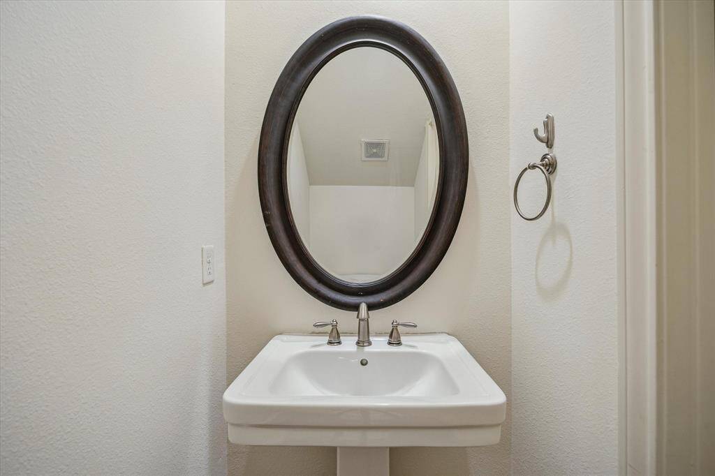 HALF BATH with pedestal sink and toilet.