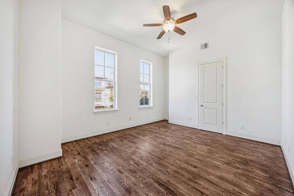 BEDROOM TWO.  All bedrooms are located on the second floor making this home very different to the usual townhome layout.   Real hardwoods continue.  No carpet!