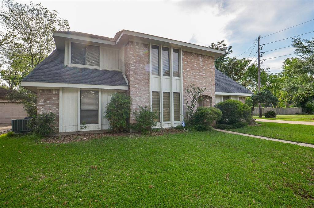 Welcoming front door with a sturdy design, set in a charming brick entryway.