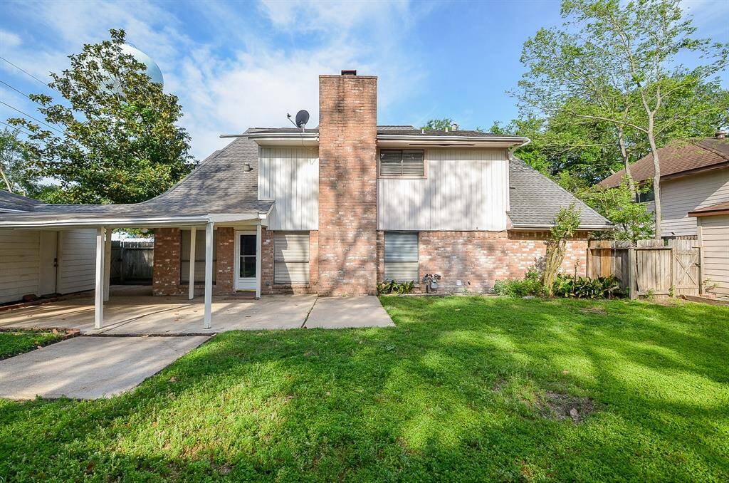Expansive backyard featuring a spacious patio, perfect for outdoor entertaining and relaxation.
