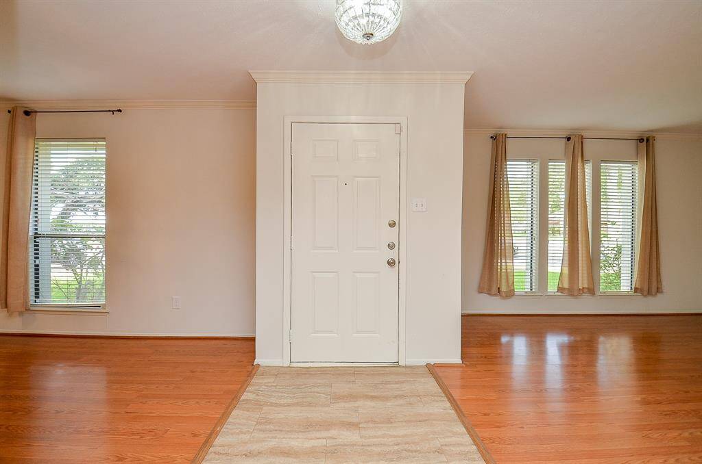 Bright and inviting living room with large windows offering serene outdoor views.