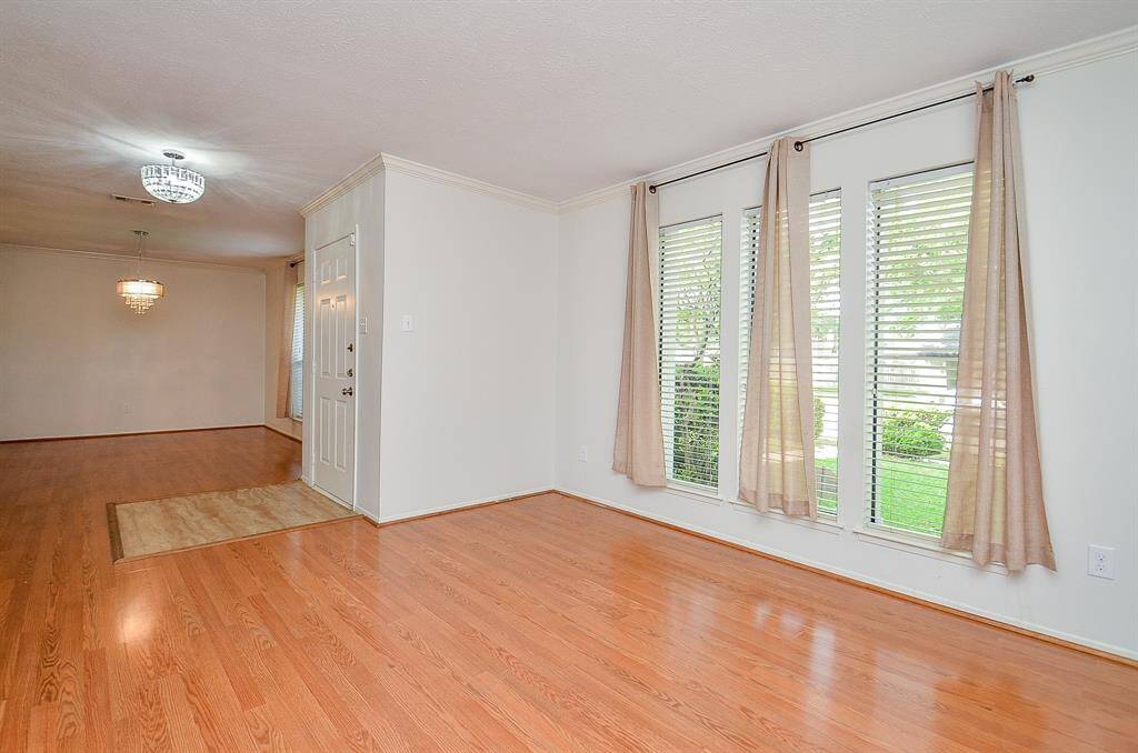 Spacious living room flows seamlessly into a stylish wet bar, perfect for entertaining.