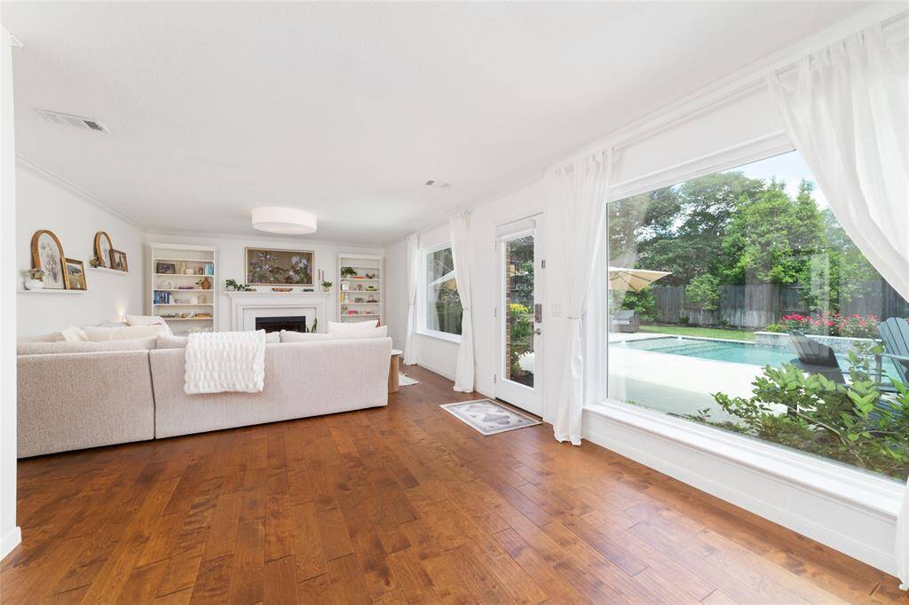 Gorgeous living room that looks out to your sparkling pool and lush landscaping.