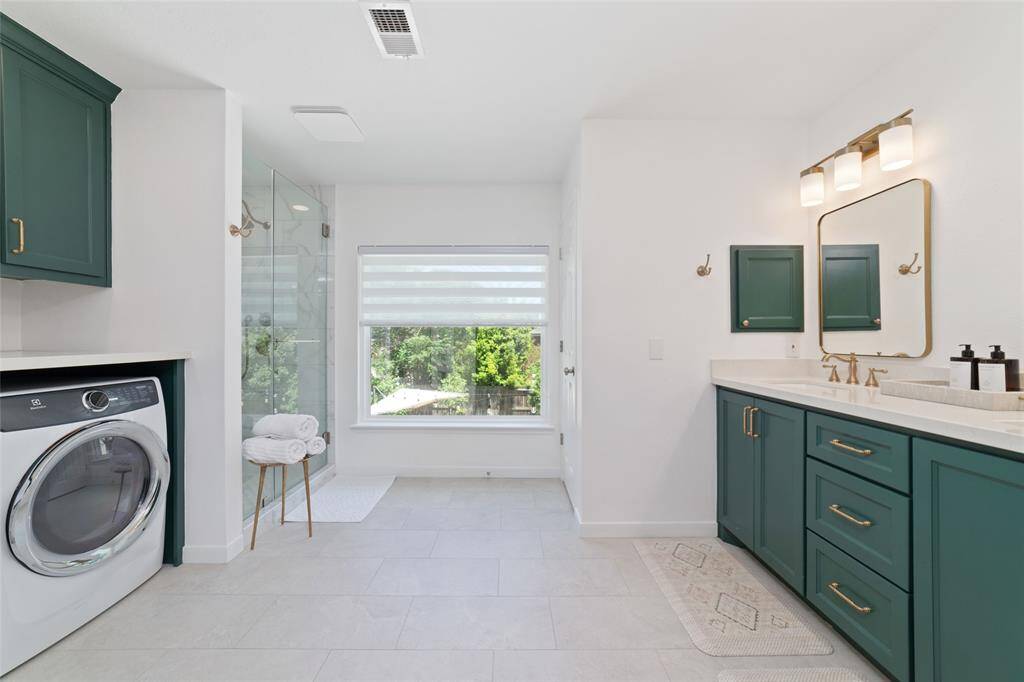 Totally remodeled primary bathroom with tall counters and seamless shower.