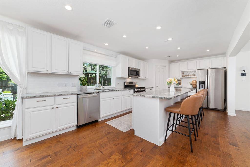Stunning granite counters with under mount sink and lighting, tons of cabinets and counter space.