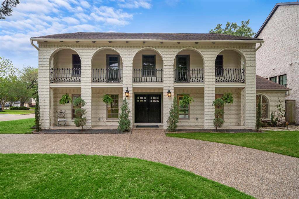 Experience elegance in this corner-lot home, featuring a grand circular driveway, expansive balcony, and inviting front porch.