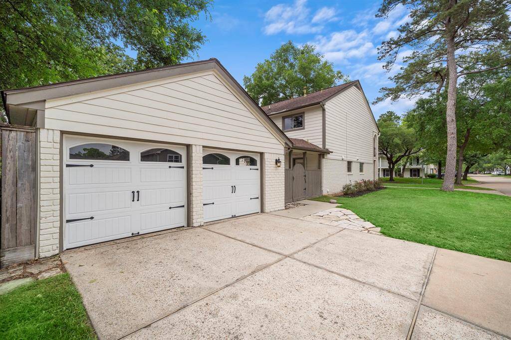 Spacious circular drive and double driveway lead to a two-car garage, offering ample parking.