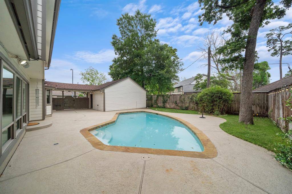 Sparkling pool and entertaining space, plus additional lawn for enjoyment.