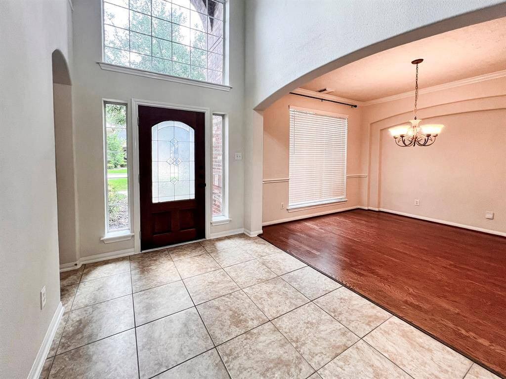 Formal front entryway leading to a spacious formal dining or living area.