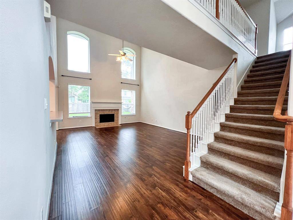 Enjoy the elegant view from the formal entry, leading seamlessly into the spacious family room at the back of the home.
