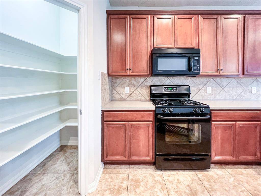 Another view of the kitchen and the open pantry.