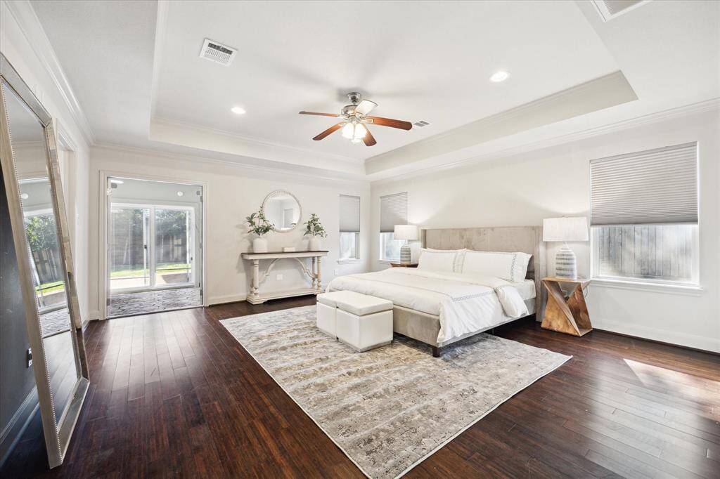 Primary bedroom with a tray ceiling.