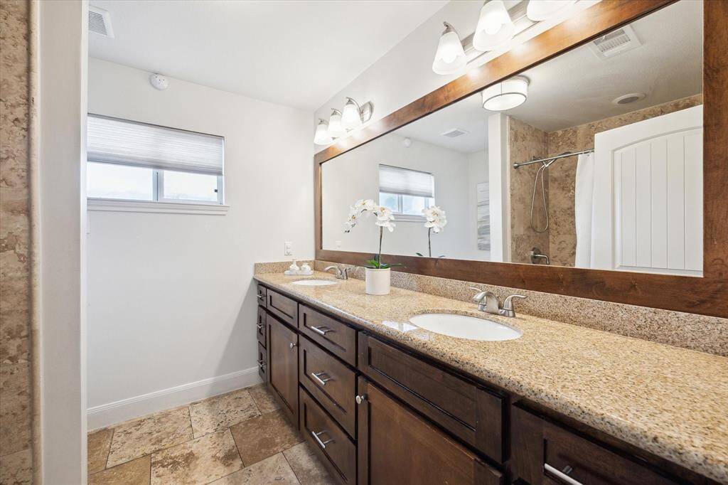 The secondary bathroom also features a spacious double vanity.