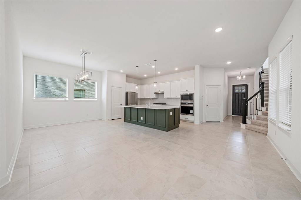 The home showcases an open-style layout that seamlessly connects the living, dining, and kitchen areas.