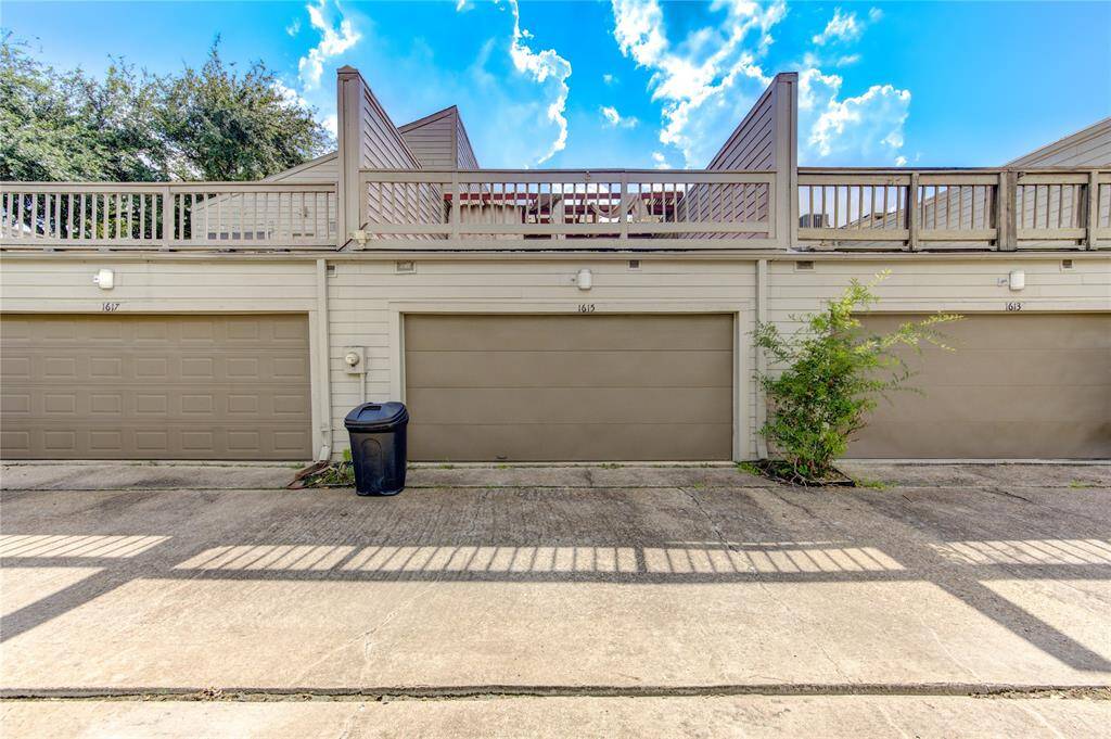 "Discover this charming townhouse, complete with a double garage and a wooden deck above for added outdoor enjoyment. The exterior boasts a well-maintained façade and trim landscaping, creating a welcoming and polished appearance.