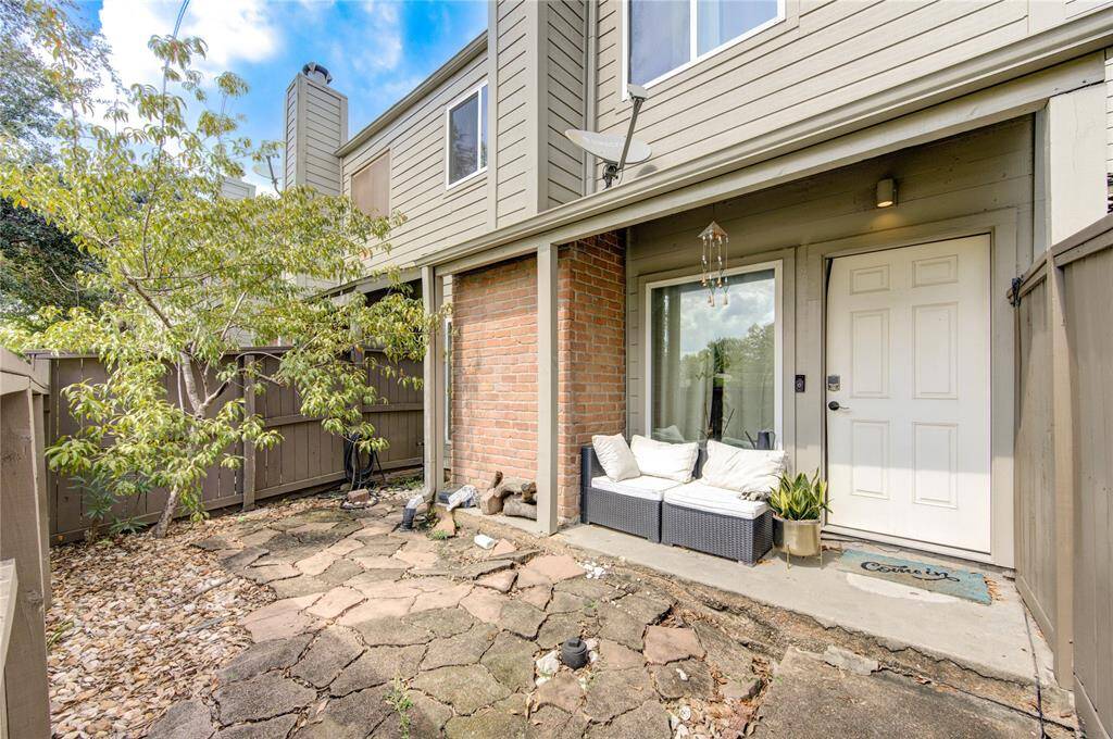 Discover the charm of this townhouse's private entrance, where a quaint blend of brick and siding sets the tone for a warm welcome.